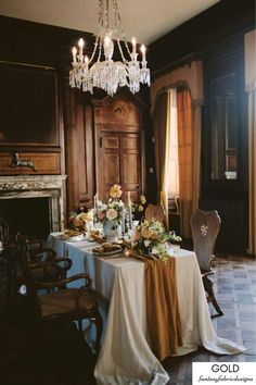 a dining room table is set with flowers and candles