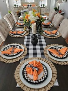 a dining room table set for four with place settings and napkins on the plates