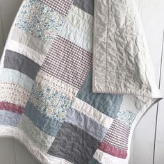 a quilt is laying on the floor next to a blanket and pillow cover that has been made into a patchwork pattern