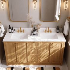 a bathroom with two sinks and mirrors in it