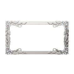 a silver metal frame with flowers and leaves on the edge, in front of a white background