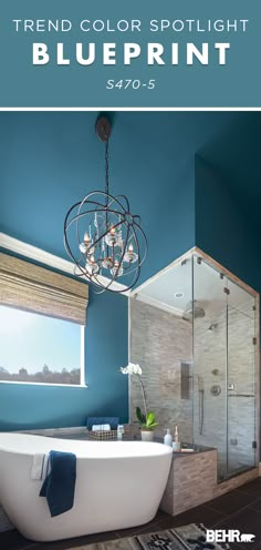 a bathroom with blue walls and white tub in the center is an image of a chandelier