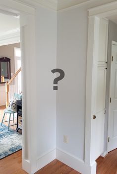 an empty room with a question mark on the wall