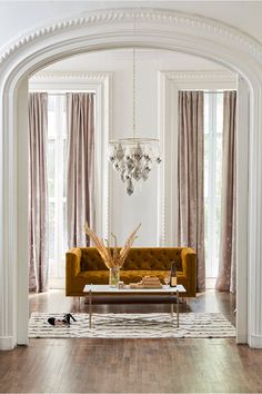 a living room filled with furniture and a chandelier