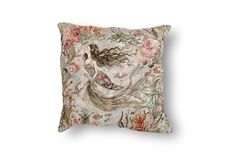 a pillow with an image of a mermaid on it