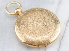 This is the most exquisite pocket watch we've had the opportunity to offer, in perfect condition, this is quite the collector's piece! This antique pocket watch dates to the 1860s, by the J.W. Tucker San Francisco watch company. The face bears two dials, one for seconds and the other for minutes and hours; black, simple hands and stark Roman Numerals. This is a hunter's case, beautifully ornate, one side has blooming flowers in its center while the other has a shield design with a scrolling "LLI Antique Pocket Watch, Gold Pocket Watch, Pocket Watch Antique, Shield Design, Watch Companies, Pocket Watches, Metal Pendant, Blooming Flowers, Roman Numerals