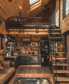 a loft style home with stairs leading up to the loft bed and kitchen in it