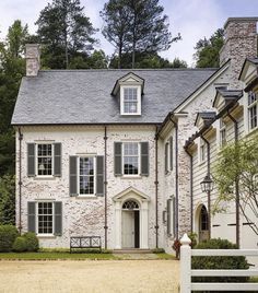 a large brick house with white trim and windows