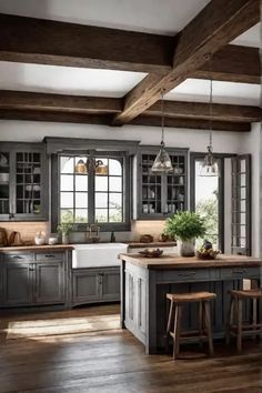 a large kitchen with wooden floors and gray cabinetry, along with an island in the middle