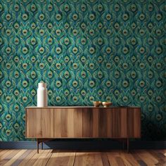 a wooden cabinet with a vase sitting on top of it next to a wallpaper