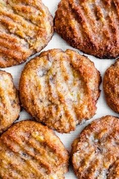 some cookies are sitting on a white tablecloth and ready to be eaten by someone