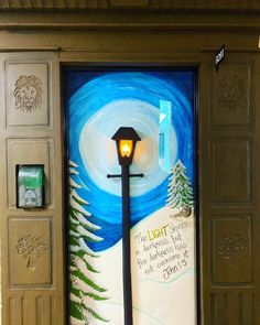 a door decorated with a painting and a light pole in the center is an image of a night sky