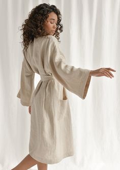 Spoil yourself with a linen bathrobe that's incredibly soft, light, and breathable. Handcrafted of premium quality European linen, this beige kimono-style bathrobe feels so good to the skin, you'll never want to take it off. The linen robe features a relaxed fit, long sleeves, an adjustable waistband, and comfy outer pockets, making it the ultimate addition to your at-home wear. The model is 175 cm (69'') tall and is wearing a bathrobe in size S/M. DETAILS - Handmade from high-quality European l Elegant Summer Linen Robe, Elegant Linen Summer Robe, Beige Long Kimono For Daywear, Elegant Linen Kimono For Summer, Elegant Linen Summer Kimono, Beige Robe For Spring Loungewear, Beige Spring Loungewear Robe, Linen Robe For Daywear, Relaxed Fit Beige Robe For Loungewear