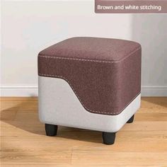 a small foot stool sitting on top of a hard wood floor next to a wall