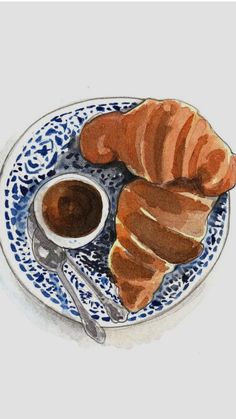 a plate with some croissants and coffee on it