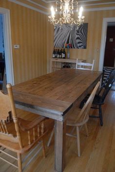 a wooden table and chairs in a room