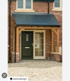 a brick building with a black front door