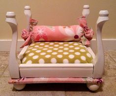 a child's rocking chair with pink and green pillows