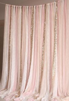 a pink curtain with gold sequins hanging from it's side and the words,