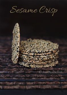 sesame crisp crackers stacked on top of each other in front of a black background