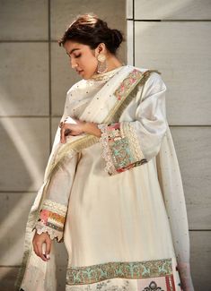 Editor's Note Featuring an ivory chanderi kurta enhanced with patchwork along the hemline. It is paired with ivory chanderi trousers and a georgette dupatta accentuated with mukesh, lace and patchwork border. Fabric: Chanderi: kurta & trousers, dupatta: georgette Color: Ivory Component: Kurta, trousers & dupatta Sleeve type: Full Neckline: Round Occasion: Festive Care: Dry Clean Only About the Designer Varun’s work marries the beauty of heritage Indian handcrafted embroideries with a modern colo Off White Raw Silk Straight Kurta Set, Off-white Palazzo Set With Dupatta And Straight Kurta, Cream Cotton Silk Kurta With Traditional Drape, Unstitched Off-white Kurta With Sheer Dupatta, Unstitched Off White Kurta With Sheer Dupatta, Bollywood Style Chanderi Palazzo Set In Off White, Off White Silk Straight Kurta Set, Bollywood Style Off White Chanderi Palazzo Set, Bollywood Style Tussar Silk Palazzo Set With Embroidered Border