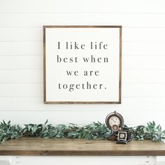 a sign that says i like life best when we are together on the wall above a mantle