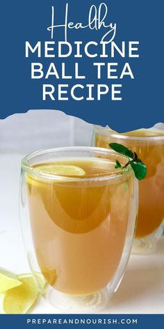 two glasses filled with tea and lemon on top of a table