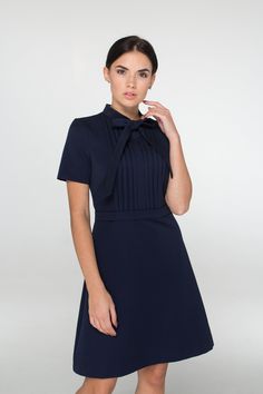 "A mini dress featuring a mock neck secured with a self-tie pussycat bow, short sleeves, pleated bust, and a a-line silhouette. - short sleeves - tie closure - bow neck - trapeze skirt - a line silhouette - above the knee mini length - belted - a concealed back zip closure Fiber: 40% viscose, 55% polyester, 5% elastane Color: navy blue For size S: dress length - 38\" (96,5 cm), sleeve length 8,66\" (22 cm) Our model wears size S and is 171 cm / 5'6\" tall You may feel free choosing the size. Jus Mini Dress With Bow For Work, Mini Length Workwear Dress With Bow, Elegant Mini Dress With Tie Neck, Chic Short Sleeve Mini Dress With Bow, Elegant Mini Dress With Tie Fastening, Workwear Mini Dress With Tie Waist, Fitted Mini Dress With Bow And Short Sleeves, Fitted Mini Dress With Tie Fastening, Elegant Short Sleeve Mini Dress With Tie Waist