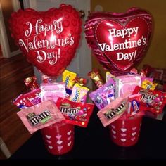 two valentine's day candy buckets with heart shaped balloons