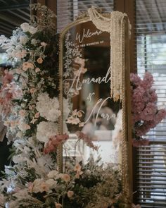 a mirror sitting on top of a table covered in flowers