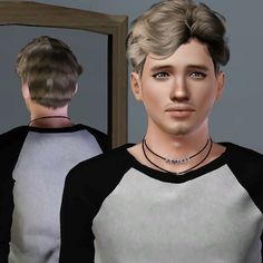 a young man is standing in front of a mirror wearing a black and white shirt