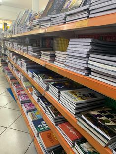 there are many books on the shelves in this store that is filled with magazines and dvds