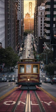 a trolley car is going down the street in san francisco, california usa on a sunny day