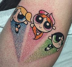 the powerpuff girls tattoo is on someone's thigh