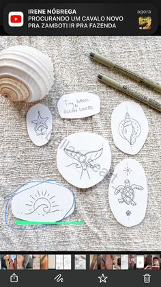 some paper plates with pictures on them next to a pen and pencils are sitting on a table