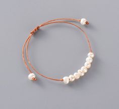 Introducing the Simplicity Pearl Bracelet, a beautiful handmade piece that embodies minimalism. Crafted with care, this bracelet features a single strand of wax cord,adorned with sweet water mother pearls. Each pearl is carefully selected to ensure stunning visual appeal. The bracelet is designed with a sliding knot, allowing for an adjustable fit to accommodate different wrist sizes comfortably. This feature makes it easy to wear and adjust. Simplicity Pearl Bracelet is a perfect accessory for Treasure Jewelry, Bracelet Apple Watch, Simple Bracelets, Protection Bracelet, Chakra Bracelet, Mala Necklace, Leather Cuffs Bracelet, String Bracelet, Healing Bracelets