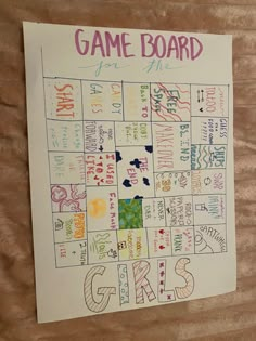 a game board for the girls on a wooden surface with writing and numbers in different colors