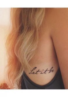 a woman with a tattoo that says let it be on her back shoulder and the words let it be written in cursive font