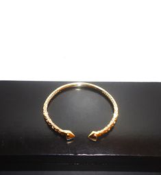 This listing is for a really beautiful 18K gold filled West Indian bangle. This bangle is designed with a beautiful intricate style carving and have arrow heads. It is adjustable and look great on the wrist. This bangle weigh 25.6g, is adjustable fits a 6-8 inch wrist. Make this a great gift or treat yourself!! Buyer lands a great deal and will not be disappointed. Adjustable Yellow Gold Hallmarked Cuff Bracelet, Ceremonial Adjustable Yellow Gold Cuff Bracelet, Adjustable Yellow Gold Cuff Bracelet For Ceremonial Wear, Adjustable Yellow Gold Cuff Bracelet For Ceremonial Occasions, Adjustable Yellow Gold Cuff Bracelet For Ceremonies, Gold Plated Bangle Bracelet, Ceremonial Gold Bangle Jubilee Bracelet, Hallmarked Gold Bangle Bracelet, Adjustable Gold Hallmarked Bangle