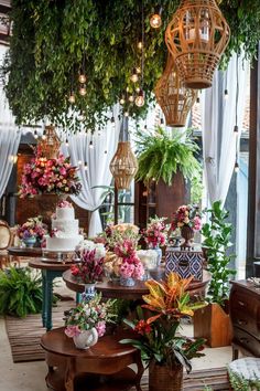 a room filled with lots of different types of flowers and plants in vases on top of tables