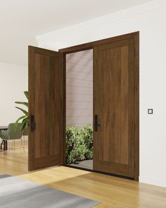 an open wooden door leading to a dining room with potted plants in the corner