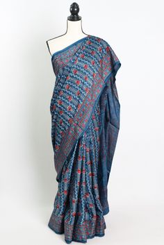 Add a touch of timeless elegance to your wardrobe with our Hand Printed Ajrakh Saree on Modal Silk in Blue. This stunning saree features intricate traditional Ajrakh printing and is crafted from luxurious modal silk fabric, making it a statement piece for any special occasion. The beautiful blue hue adds a pop of color to your ensemble, while the soft and smooth texture of the modal silk ensures utmost comfort. Each saree is meticulously hand printed by skilled artisans, making it a truly unique Blue Kalamkari Pre-draped Saree For Diwali, Indigo Traditional Drape For Navratri, Blue Chanderi Pre-draped Saree With Motifs, Bohemian Style Pre-draped Saree In Slub Silk, Traditional Block Print Cotton Silk Pre-draped Saree, Bohemian Style Pre-draped Slub Silk Saree, Blue Kalamkari Print Unstitched Saree, Blue Cotton Silk Saree With Kalamkari Print, Unstitched Blue Kalamkari Saree