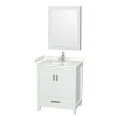 a white bathroom vanity with a mirror above it and a sink under the counter top