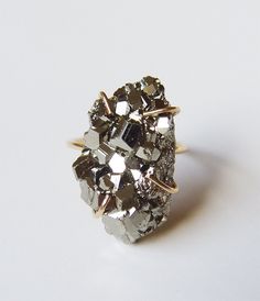 This raw Pyrite Ring features absolutely beautiful crystals.  As a true statement ring, it will bring life into any tired outfit and will pair  perfect with your little black dress. It would make the perfect addition to your wardrobe or an excellent holiday gift. - Raw Freeform Pyrite, range from around 12mm to 18mm long - Available in Recycled 14 Karat Gold Fill or Sterling Silver - Handmade to order in my California studio. - Please allow for natural variation in crystals.  - No two are the same. They are unique just like you! - Some are Oval or Teardrop shaped, some are more free form on top.  Current stones are around 12-15mm long - Stones are cut on the sides and back for stone setting. - Order in a warm 14k gold fill or cool sterling silver setting. - Limited Edition Piece - Zodiac B Pyrite Ring, Trinity Ring, Ring Man, Druzy Jewelry, Pyrite Crystal, Etsy Gold Ring, Bohemian Rings, Gold Filled Ring, Earrings Rings