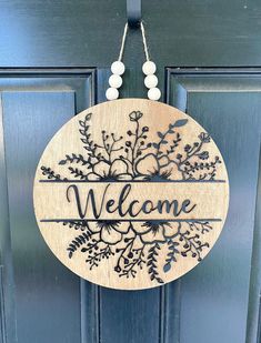 a welcome sign hanging on the front door