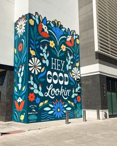 a mural on the side of a building that says hey good lookin with flowers