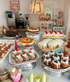 a table filled with lots of different types of cakes and desserts on top of it