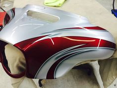 a red and silver helmet sitting on top of a table