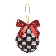 a black and white ornament with a red bow hanging from it's side