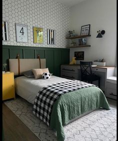 a bed room with a neatly made bed next to a dresser and desk in front of a window